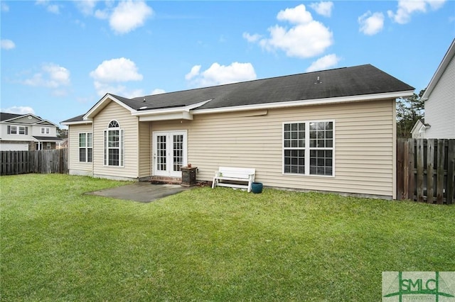 back of property featuring a patio, a yard, and french doors