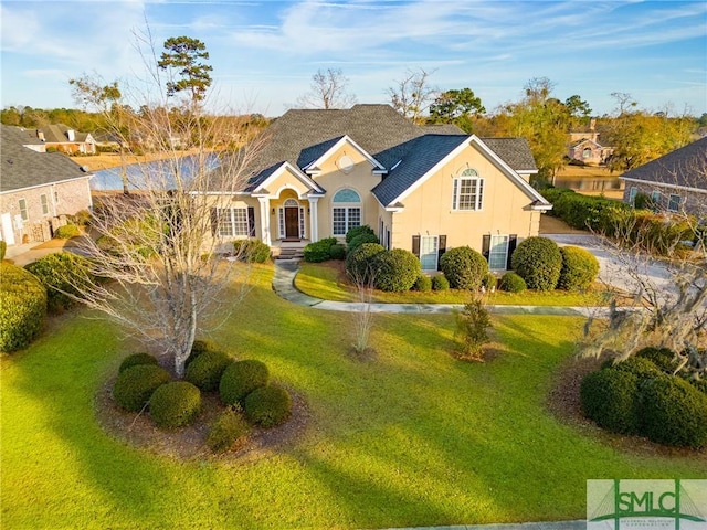 single story home featuring a front lawn