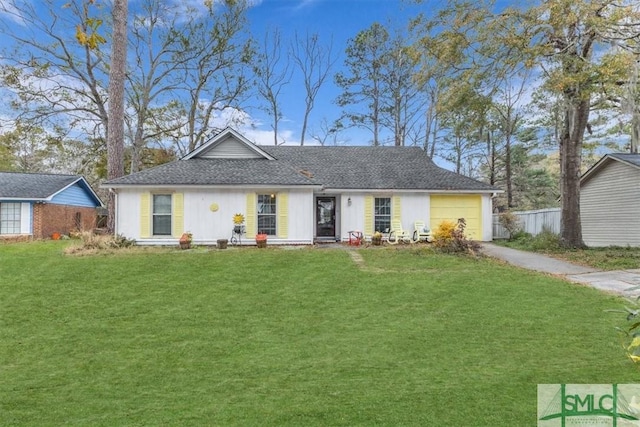 ranch-style house with a garage and a front lawn