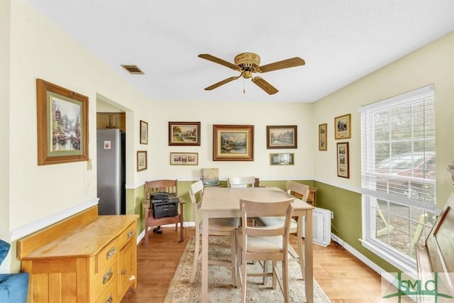 dining space featuring ceiling fan and light wood-type flooring