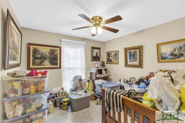 bedroom with a textured ceiling and ceiling fan