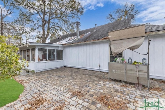 back of house featuring a patio and a sunroom