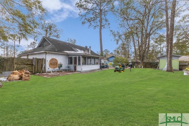 back of property with a sunroom and a lawn