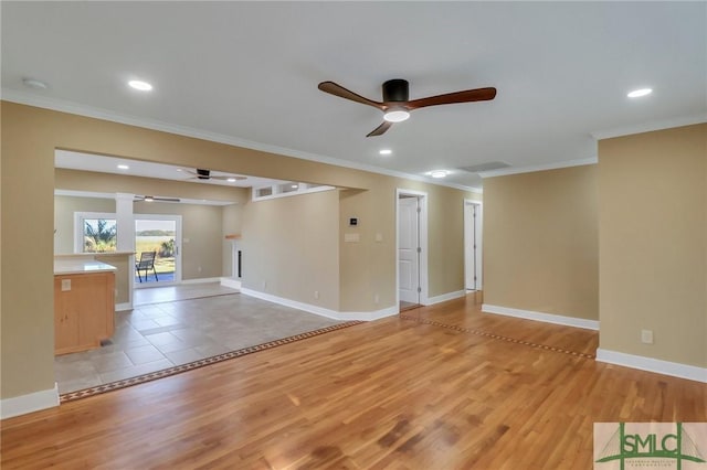 unfurnished living room with ornamental molding, light hardwood / wood-style floors, and ceiling fan