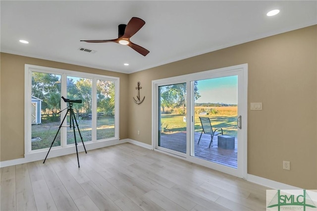 unfurnished room featuring ceiling fan, plenty of natural light, and light hardwood / wood-style flooring