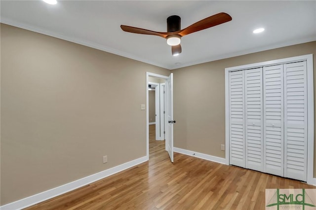 unfurnished bedroom with light hardwood / wood-style flooring, ceiling fan, and a closet