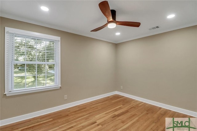 spare room with hardwood / wood-style floors and ceiling fan