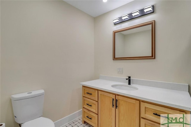 bathroom featuring tile patterned floors, vanity, and toilet