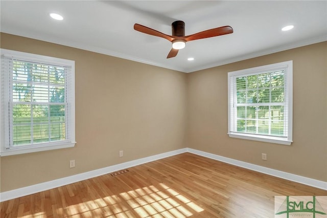 empty room featuring ornamental molding, ceiling fan, and light hardwood / wood-style floors