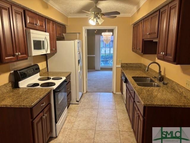 kitchen featuring sink, white appliances, ornamental molding, and a textured ceiling