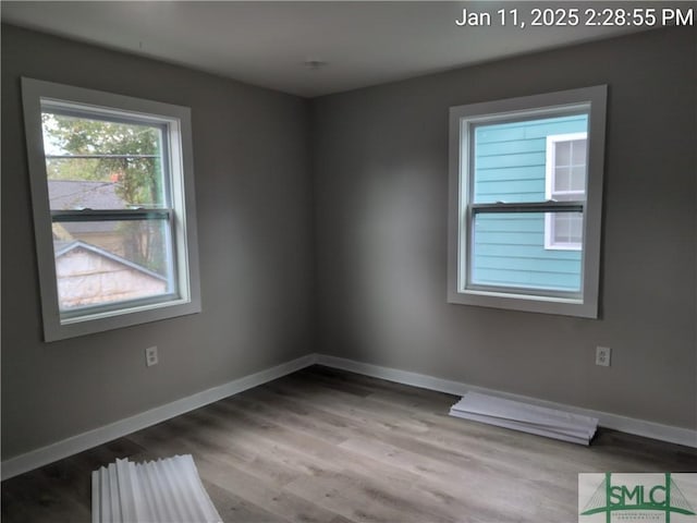 empty room with light hardwood / wood-style flooring