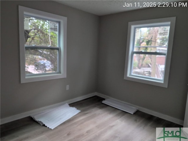 unfurnished room featuring light hardwood / wood-style floors