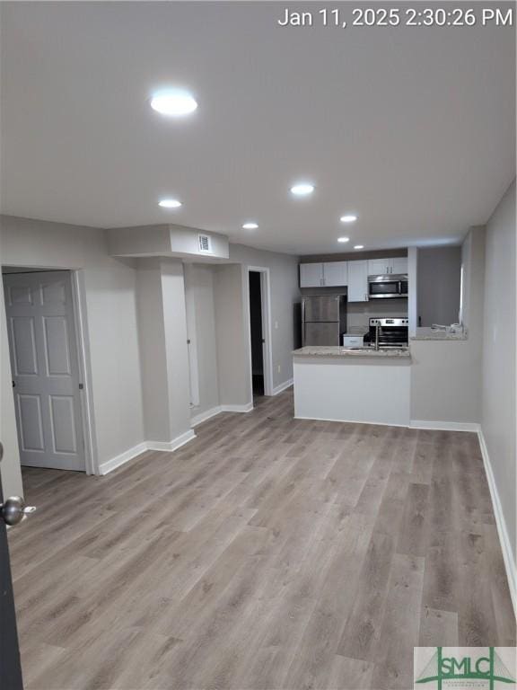 unfurnished living room featuring light hardwood / wood-style floors