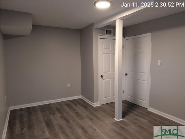 basement featuring dark hardwood / wood-style flooring