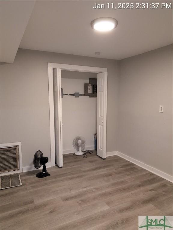 interior space with wood-type flooring and heating unit