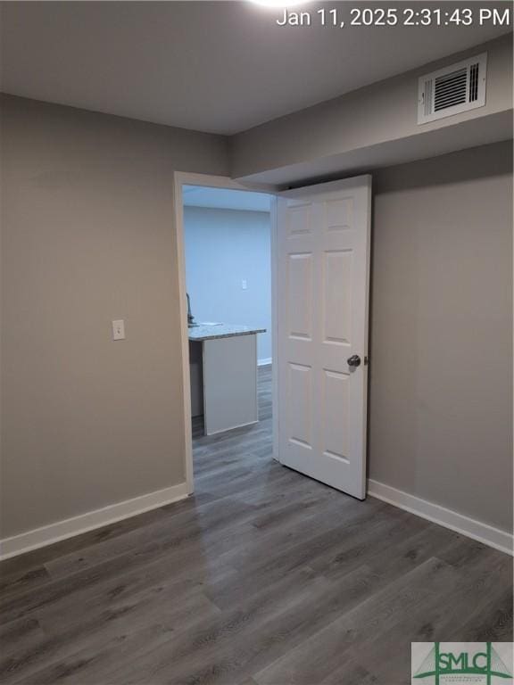 unfurnished room with dark hardwood / wood-style floors