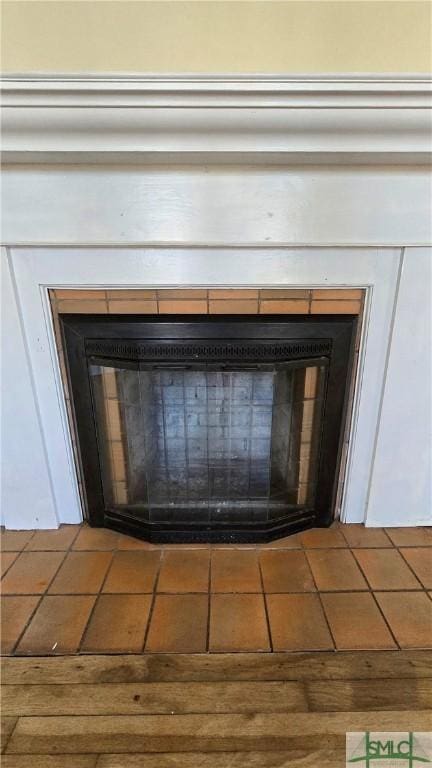 interior details featuring a tiled fireplace