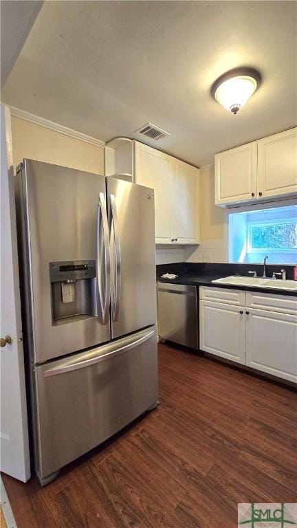 kitchen featuring stainless steel appliances, white cabinetry, and sink