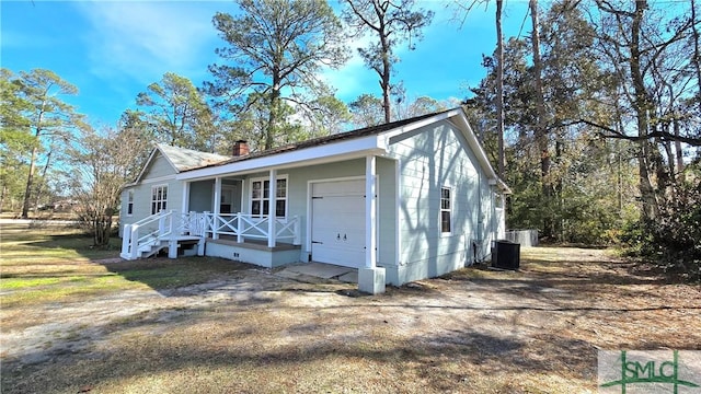 exterior space featuring a chimney, covered porch, crawl space, and central air condition unit