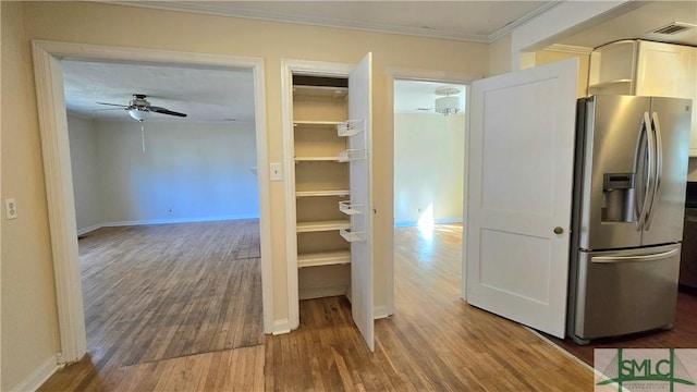 interior space with hardwood / wood-style flooring and ornamental molding