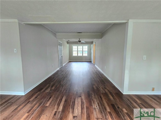 unfurnished room featuring dark wood-type flooring, baseboards, a ceiling fan, and visible vents