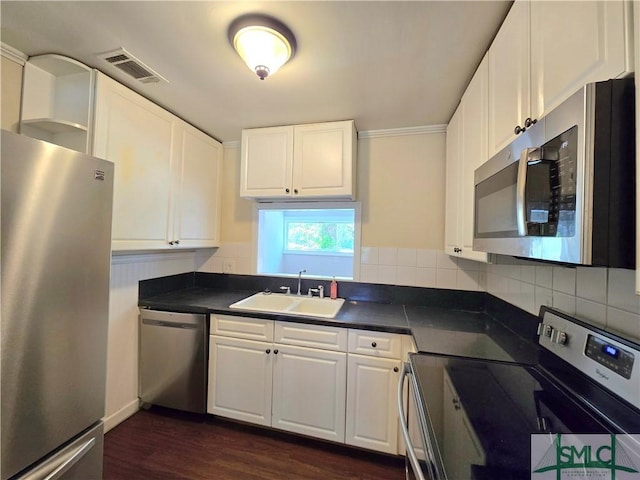 kitchen featuring dark countertops, visible vents, a sink, and appliances with stainless steel finishes