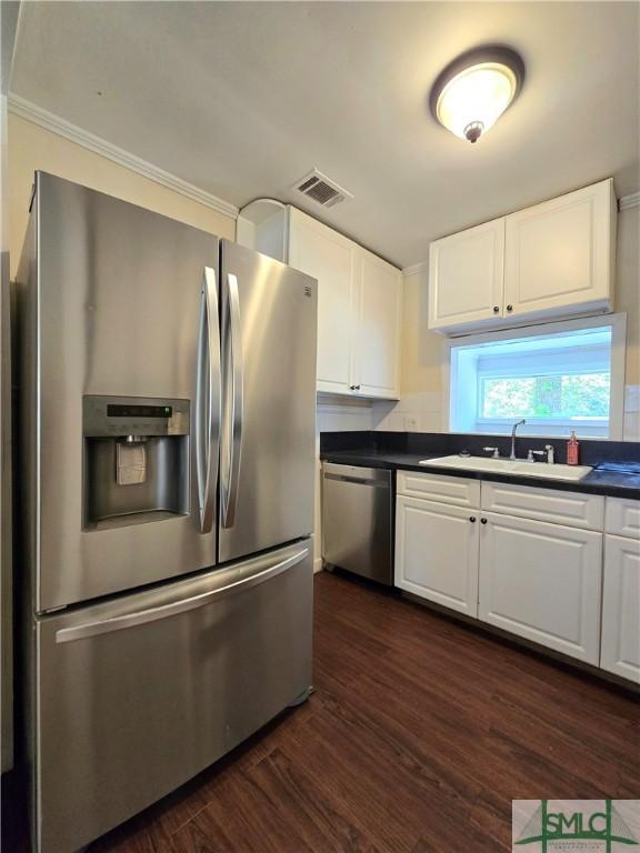 kitchen featuring visible vents, white cabinets, appliances with stainless steel finishes, and dark wood-style floors