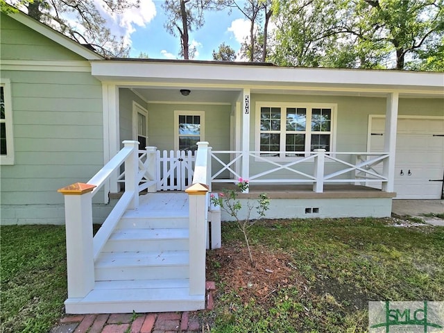 doorway to property with an attached garage and covered porch