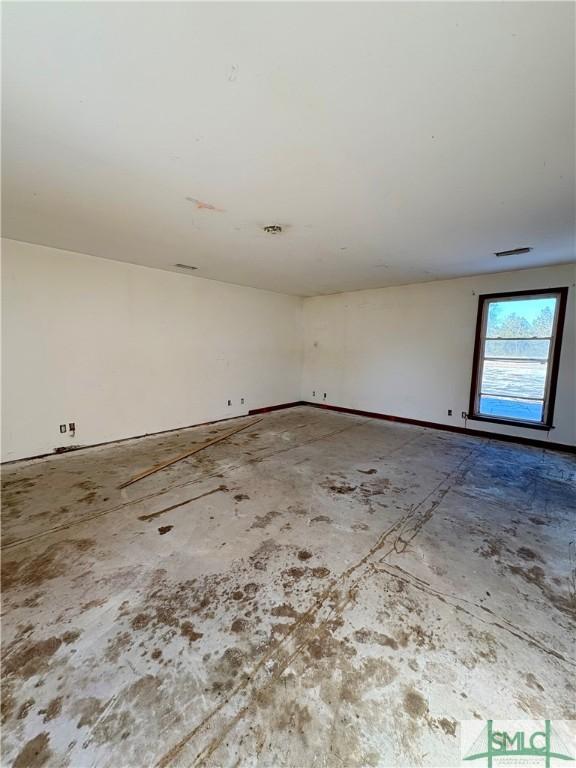 unfurnished room featuring concrete floors