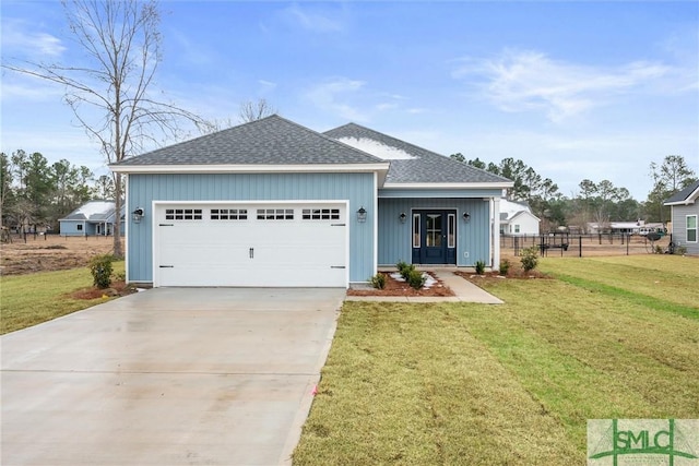 view of front of house with a garage and a front lawn