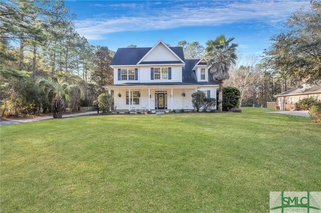 view of front of home with a front yard and covered porch