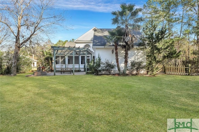 back of property featuring a yard, a pergola, and a patio area