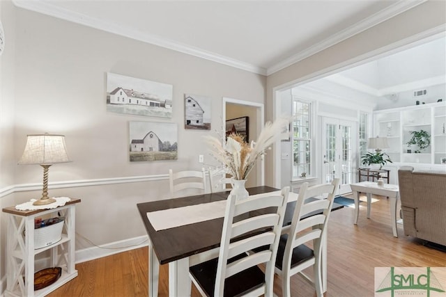 dining room featuring crown molding and wood-type flooring