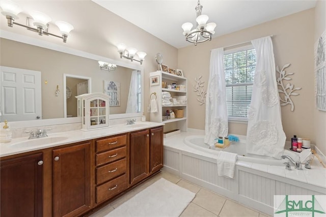 bathroom with vanity, a chandelier, tile patterned flooring, and a bathtub