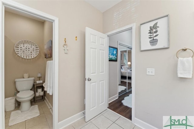 bathroom featuring tile patterned flooring and toilet