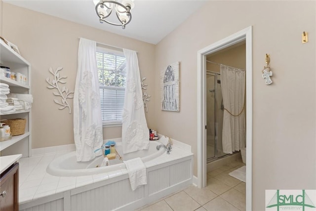 bathroom featuring vanity, tile patterned flooring, plus walk in shower, and a chandelier