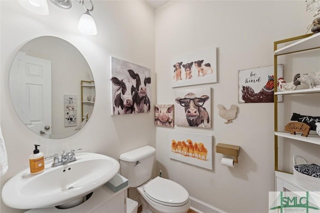 bathroom featuring sink and toilet