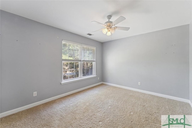 carpeted spare room featuring ceiling fan