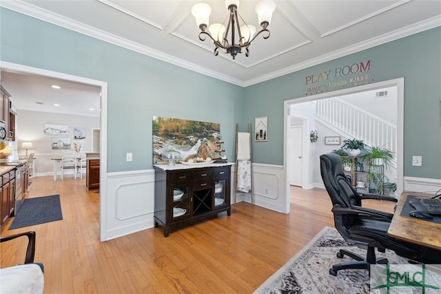 office featuring ornamental molding, an inviting chandelier, and light wood-type flooring