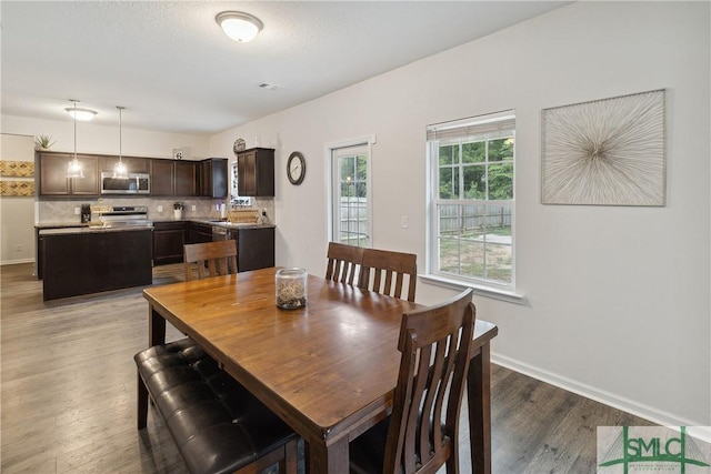 dining room with dark wood-type flooring