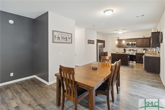 dining area featuring hardwood / wood-style flooring