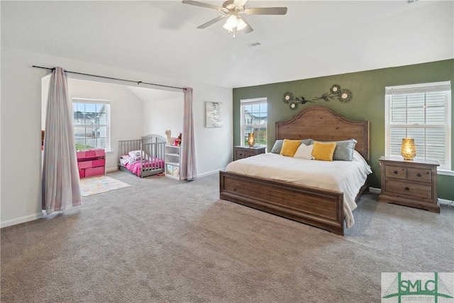 carpeted bedroom featuring ceiling fan and vaulted ceiling