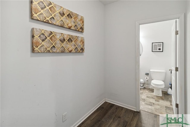 bathroom featuring hardwood / wood-style flooring and toilet