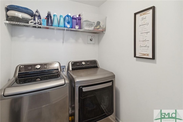 clothes washing area with separate washer and dryer