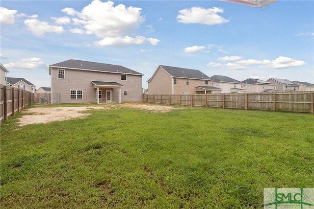 back of house featuring a yard