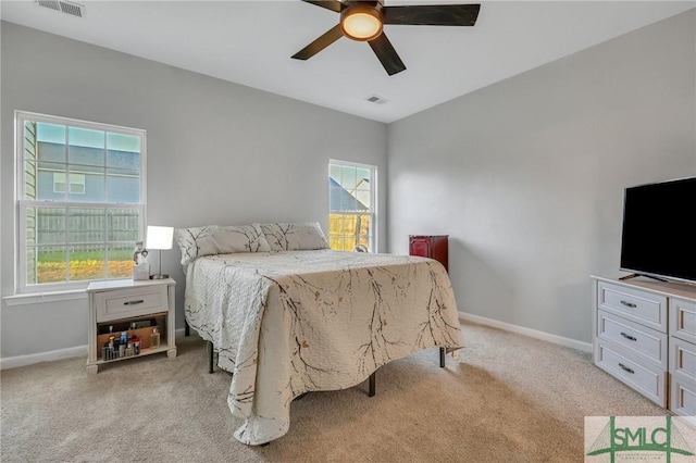 bedroom featuring light carpet, baseboards, visible vents, and a ceiling fan