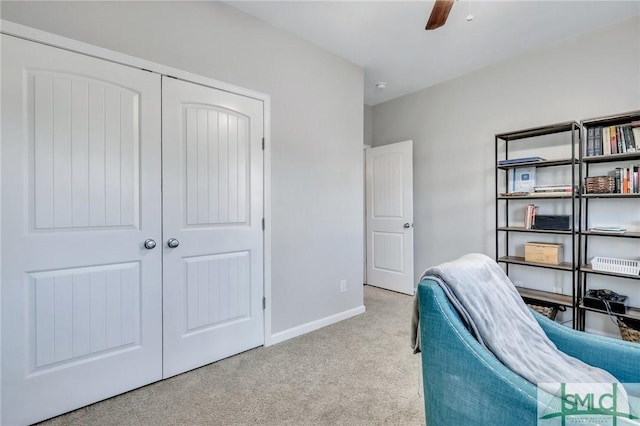 home office featuring a ceiling fan, light carpet, and baseboards