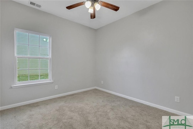 spare room with ceiling fan, carpet flooring, visible vents, and baseboards