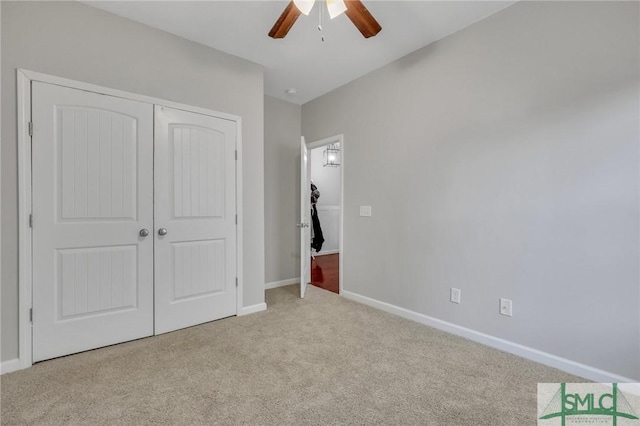 unfurnished bedroom featuring baseboards, a closet, a ceiling fan, and light colored carpet