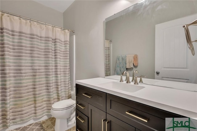 bathroom with shower / bath combo, vanity, and toilet